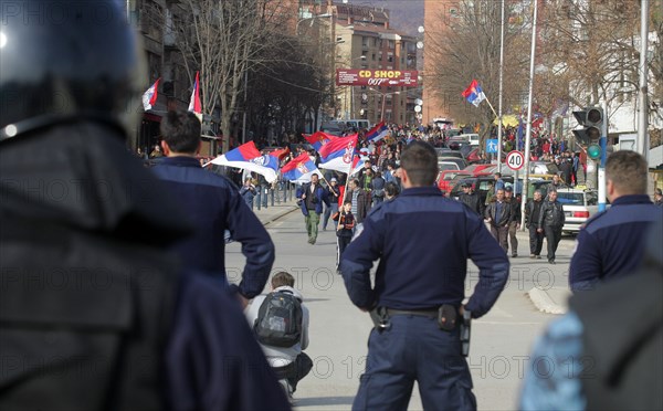 Police officers stand in a street of mitrovica town, kosovo, february 25, 2008.