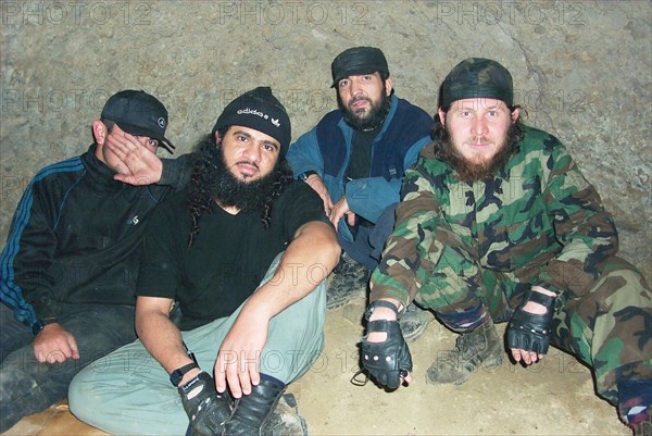 Moscow, russia, july 26, 2002, khattab's right-hand man isayev, aka the 'elsi the red', achimez gochiyayev, khattab and his bodyguard (r-l) seen in the photo made public by the federal secirity service