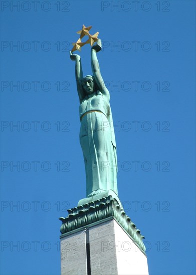 Top section of the freedom monument in the center of riga, latvia, 2003, the monument was designed by sculptor k,zale and unveiled in 1935, scenes of latvia's struggle for independence are depicted around the base.