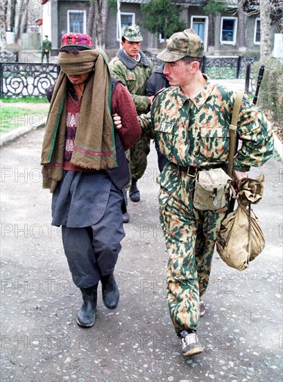 Drug trafficking - tajikistan, october 6, 2002, an afghani man (l) shown being detained by a border guard of the pyandzhsky border detachment, a big batch of heroin weighing 138,5 kilograms, which had been seized from smugglers on the tajik-afghan border was destroyed by border guards on the 4th of october, this has aggravated the border situation, the border detachments are being gun-fired at by drug traffickers more frequently, iranian-made mines were found and deactivated.