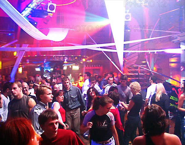 Young latvians dancing at nautilus a popular night club in riga's old city, latvia, 2003.