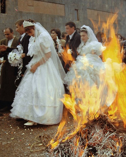 Brides and bridegrooms heading for the church blessing on valentine's day, february 14, in yerevan, armenia, 2/14/02, newly weds who jump over a campfire three times are believed to be healthy and wealthy through the year.