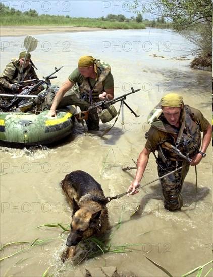 Russian border guards of pyandzhsky border detachment, tajikistan, september 21, 2002, russian border guards of pyandzhsky border detachment (in pic) twice had armed clashes with drug smugglers who attempted to escape from afganistan by inflatable boats last night, as a result over 50 kg of heroin was confiscated and delivered to pyndzhsky detachment headquarters to be examined, weighed and destroyed.