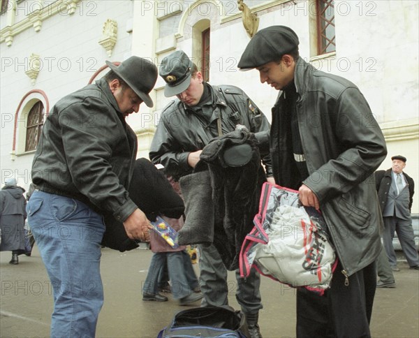 Moscow,russia, october 25, policeman examines the luggage of passengers who arrived in moscow on thursday, security has been tightened in the russian capital in the wake of an act of terror when over 700 people were taken hostage by chechen terrorists at the dubrovka theatre centre.