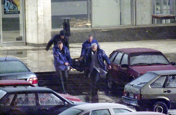 Moscow, russia,10/26/02: chechen hostage crisis: a dead body is carried out of the theater center, presumably it is the body of the man who entered the building tonight, probably a relative of a hostage.