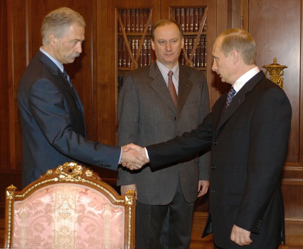 Moscow, russia,10/26/02: chechen hostage crisis: president vladimir putin (r) had a working meeting with federal security service chief nikolai patrushev (c) and interior minister boris gryzlov (l), they reported to the president on the completion of the hostage release operation, (photo itar-tass / vladimir rodionov) .