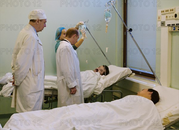 Moscow, russia,10/26/02: chechen hostage crisis: president vladimir putin (c) talks to doctors, president visited released hostages in need of medical attention who were taken to the sklifosovsky first aid hospital.