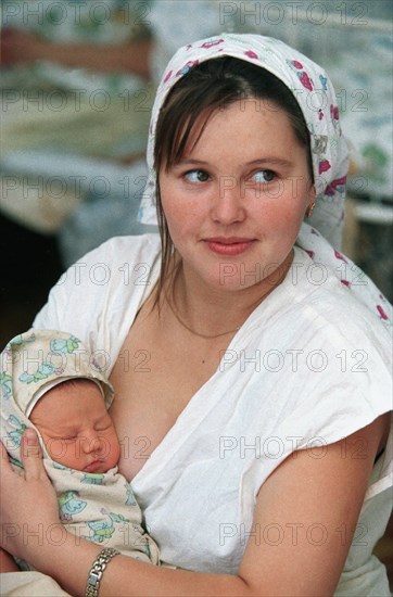 Chita, russia, 2001, viktoria kolobova with her new-born son kolya, now women in chita give birth to two or three babies while five years ago they could afford only one,  photo itar-tass/yevgeny yepachintsev .