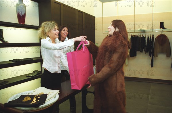 Moscow, russia, 2003, customer and staff of an expensive store in crocus city shopping center, moscow.