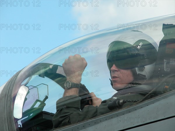 Caption: tas13: mediterranean sea, uss theodore roosevelt, march 22, 2003, pilot of a fa18 hornet fighter seen in the cockpit after returning on board of the theodore roosevelt aircraft carrier from the first raid on iraq, (photo itar-tass / konstantin yelovsky) .