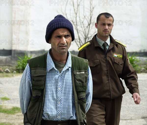 A drug-trafficer arrested by the tajik police, tajikistan, april 16, 2002, 40-year-old safar rakhmonov (l) was captured with 30 kg of heroin in his belongings by russian border guards and local police in the course of a joint operation,the trespasser explained to the police that he had been taken hostage by the narcodealers in afganistan who offered him to deliver the batch of drugs to tajikistan for his liberation.