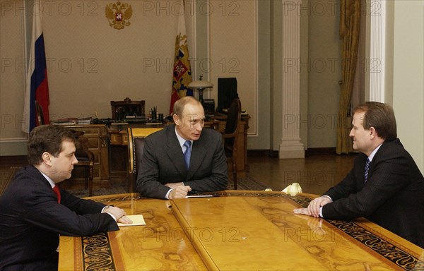 Head of the russian presidential staff dmitry medvedev (left), russian president vladimir putin (c), and viktor medvedchuk, chief of staff of the ukrainian president talk during the meeting, moscow,russia, april 16 2004.