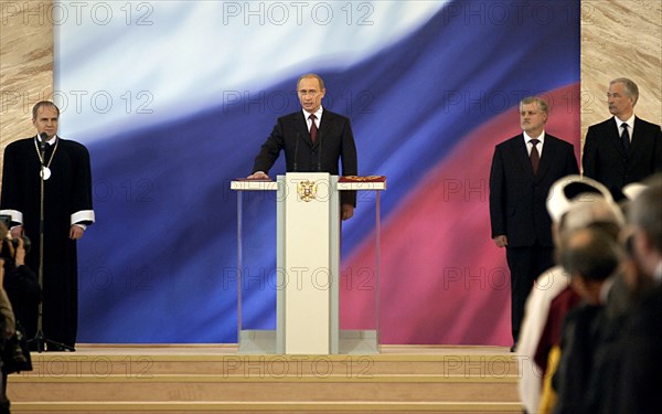 President vladimir putin (c) taking an oath during ceremony of his inauguration, chairman of the russian constitutional court valery zorkin (l) and chairman of houses of federal assembly sergei mironov (s-r) and  boris gryzlov (r), may 7, 2004, moscow, russia.