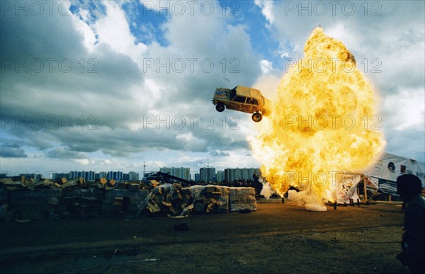 A car flying through a ball of fire at the 4th international stunt driving festival in khodynskoye field, moscow, may 2001.