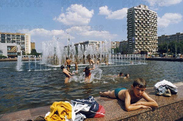 Childen playing in a public fountain in samara, july 1999.