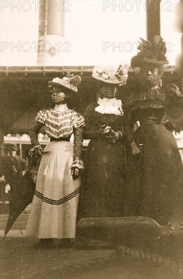 Three African American women, full-length portrait, standing, at the State Fair at Saint Paul, Minn.