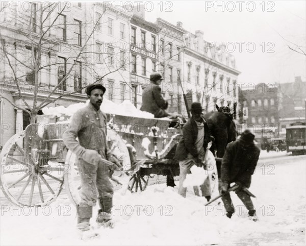 African American men shoveling snow in street, Washington, D.C