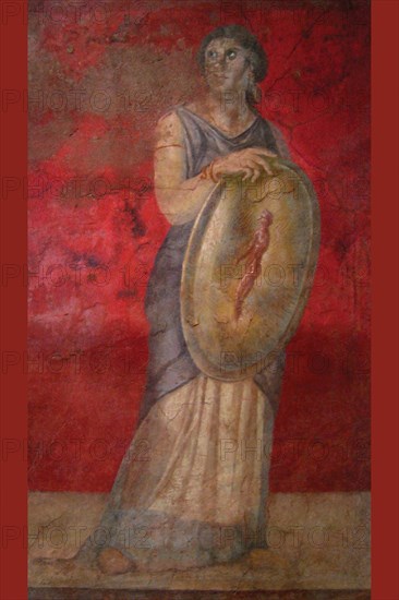 Standing woman holding a shield