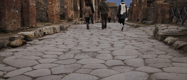 Pompeii. Tourists in the cobbled street.