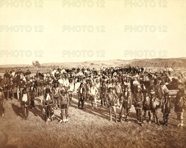 At the Dance. Part of the 8th U.S. Cavalry and 3rd Infantry at the great Indian Grass Dance on Reservation 1890.