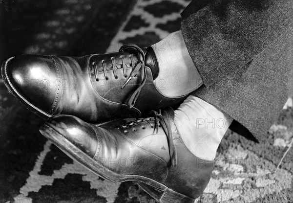 Man showing off his sharkskin shoes circa 1919 .