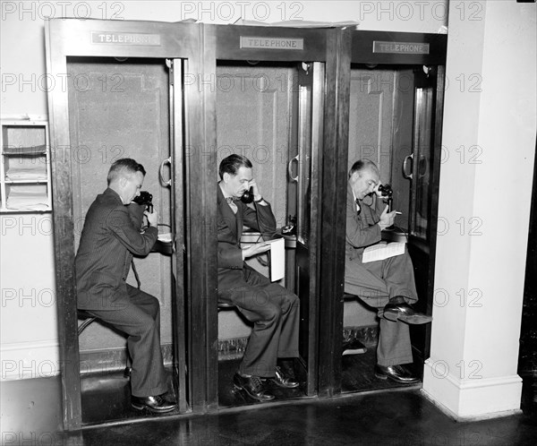 Reporters in White House press room calling in their stories to newspaper editors  circa 1937.