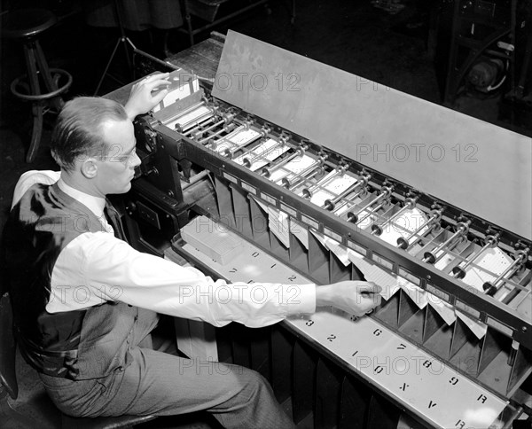 Man working Card sorter for tabulating machine circa 1940.