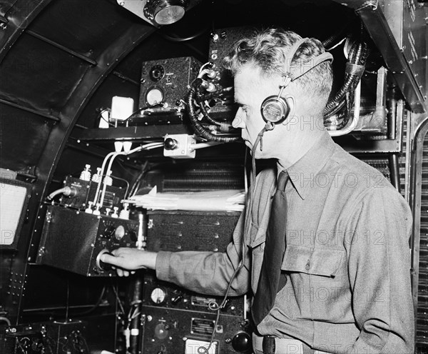 Part of flight crew of a passenger plane working on instruments circa 1936.