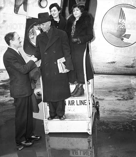 Group of passengers exiting an airplane circa February 1936.