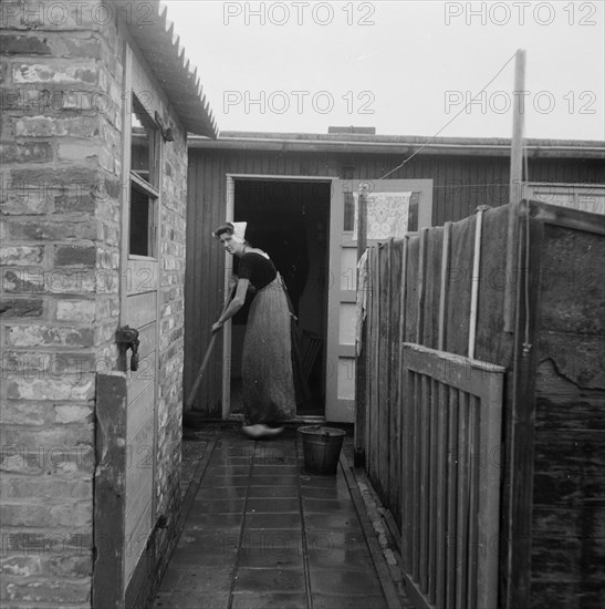 Zeeland series - Woman mopping outdoors - Date October 23, 1947.