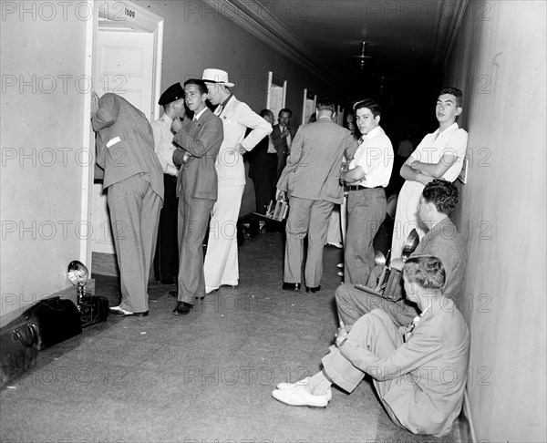 Photographers in hallway waiting circa 1936.