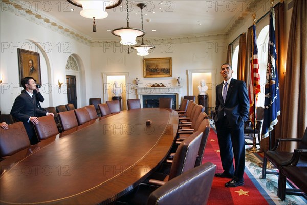 President Barack Obama surveys the Cabinet room with family members while touring the White House on his first day in office. 1/21/09.