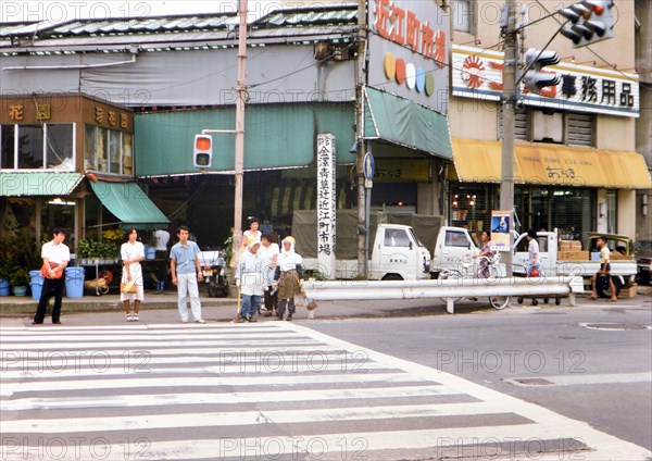 Lady street cleaners waiting at traffic crossing in Kanazawa Japan circa 1976.