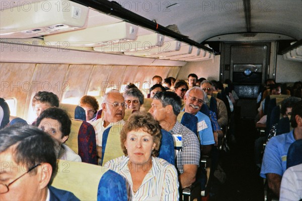 (R) Passengers on an airplane in 1987.