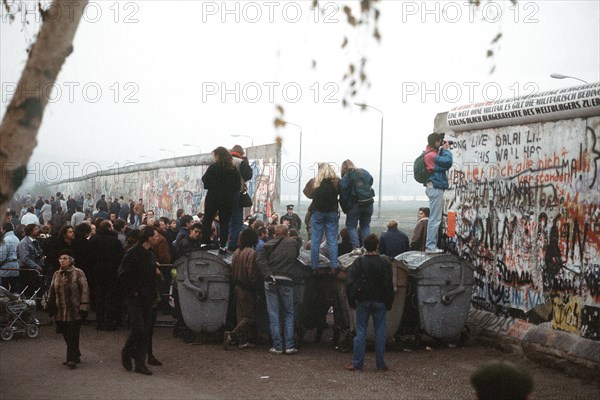 A crowd of West German citizens gathers at the newly created opening in the Berlin Wall at Potsdamer Platz..