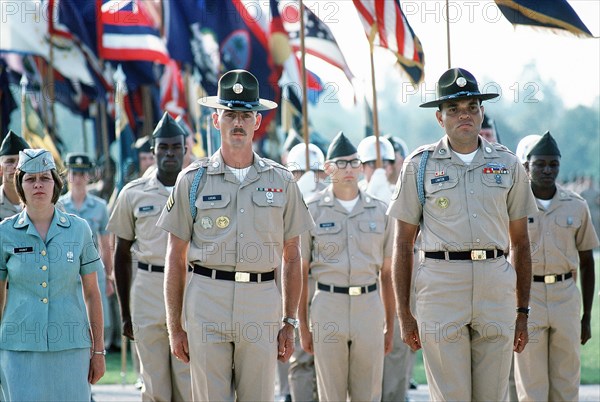 1977 - US Army drill instructors lead a formation of troops on the parade ground.