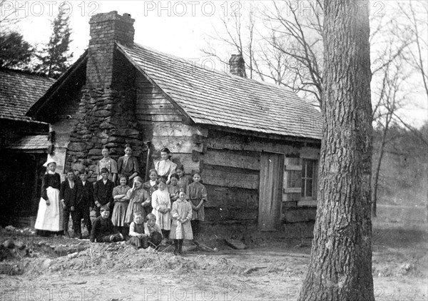 Large family of 15 mountaineers at their cabin in rural United States