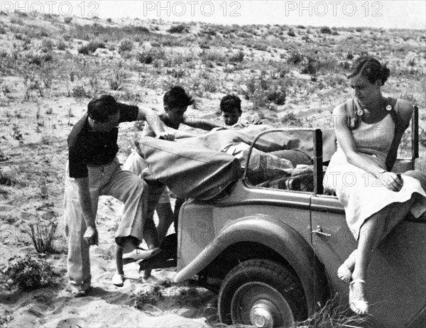 Car stuck in sand of a beach near Viareggio