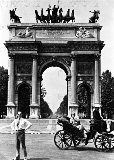 Tourist standing in front of the Arco della Pace in Milan Italy