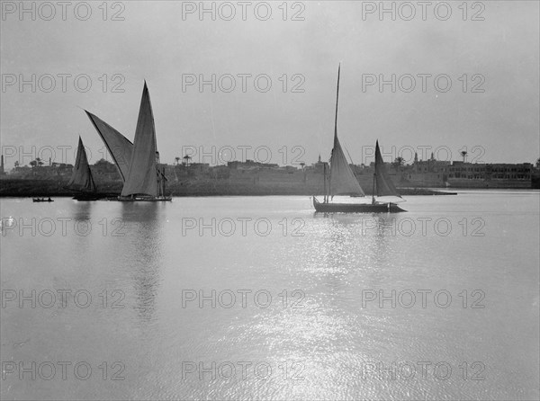 Scene along the Cairo banks of the Nile River, many sailboats on the river  ca. between 1934 and 1939