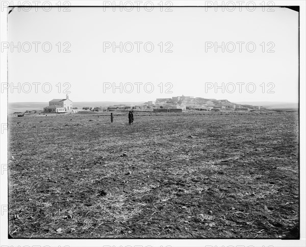 East of Jordan and the Dead Sea. General view of Madeba (or Madaba Jordan), men walking in a field ca. between 1898 and 1914