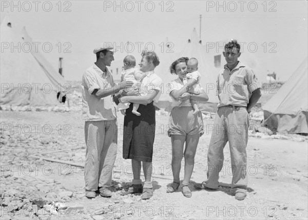 Maalek Hachamisha (Ma'ale HaHamisha) Kibbutz. Group of colonials, immigrants, holding babies ca. 1939