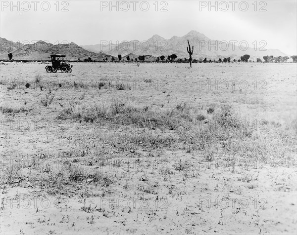 Early 20th century car traversing through the desert ca.  between 1910 and 1935