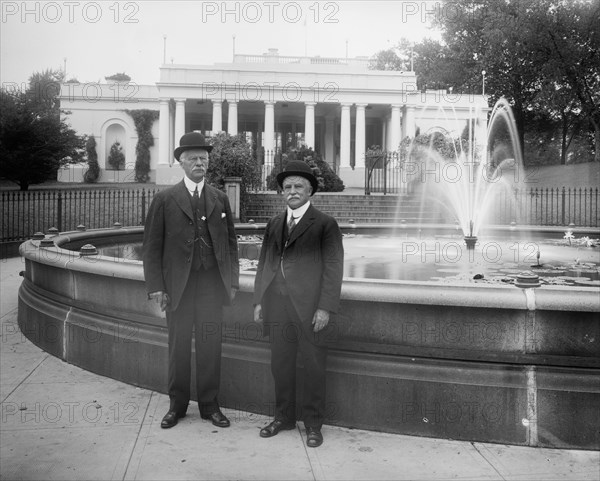 Thomas H. Fearey & Charles DeMitt Marcey standing next to a water fountain ca.  between 1910 and 1926