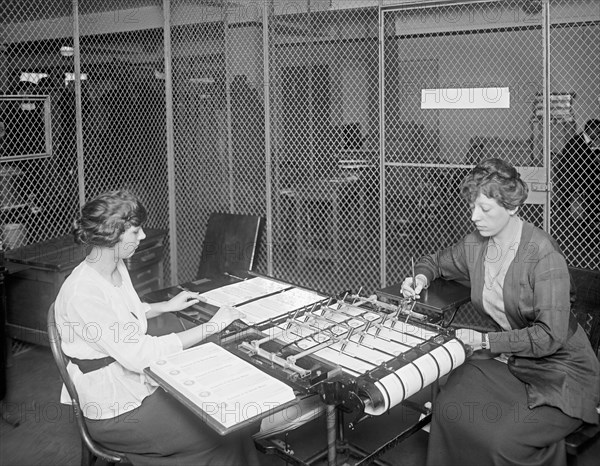 Women working at War Risk check writing ca. between 1909 and 1940