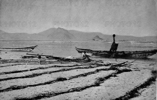 View of  Khor Ghorera (Yemen) in January 1914. Also known as the lagoon, or lake, of Sheikh Said. Several huts are visible across the lake. A  small Turkish garrison occupied Fort Turba at the top of a promontory nearby.