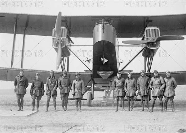 Aviators at Bolling Field, standing in front of a Hadley Page plane on polo grounds, with an obvious warning sign ca. between 1909 and 1932