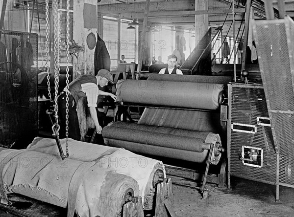 Workers manufacturing of cloth for army uniforms ca. between 1909 and 1920