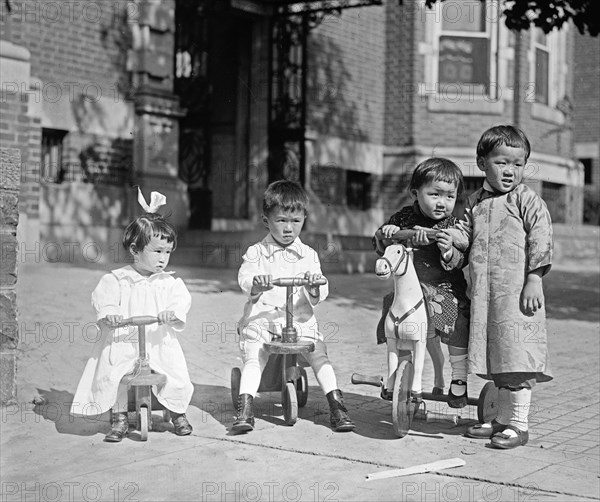 Chinese children playing on tricycles ca.  between 1918 and 1920