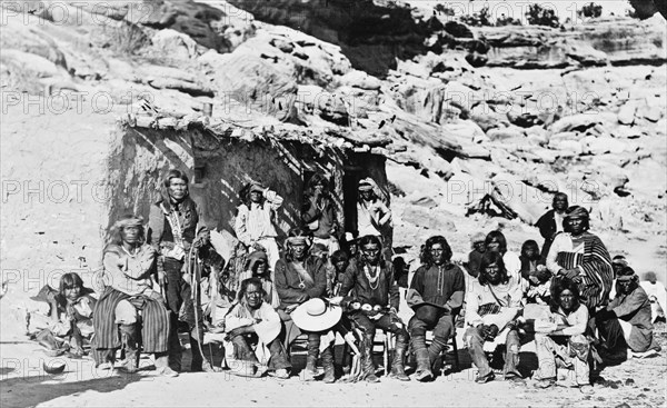 Paiute Indian group posed in front of adobe house ca. 1909